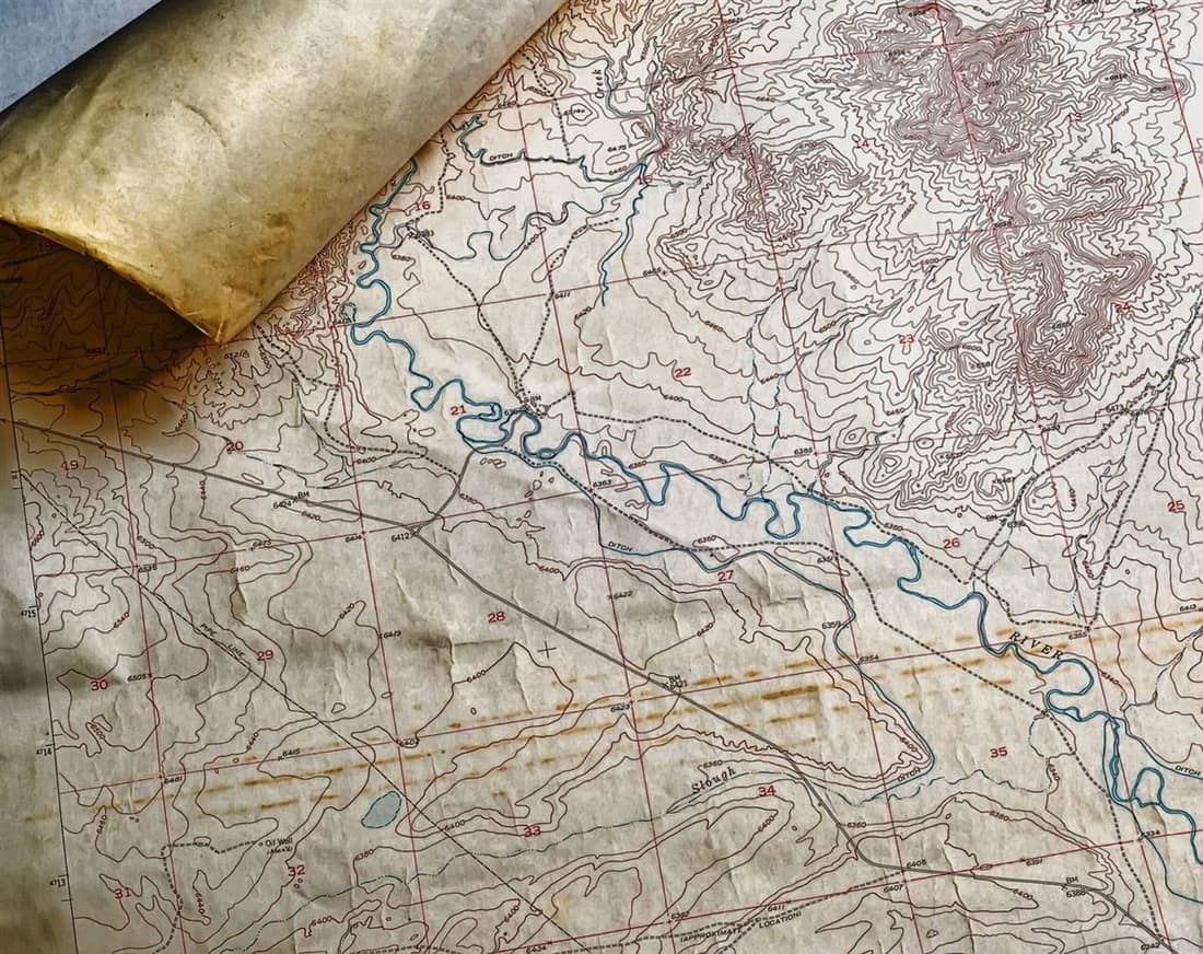 Antique paper topographic map with contour lines and a winding river